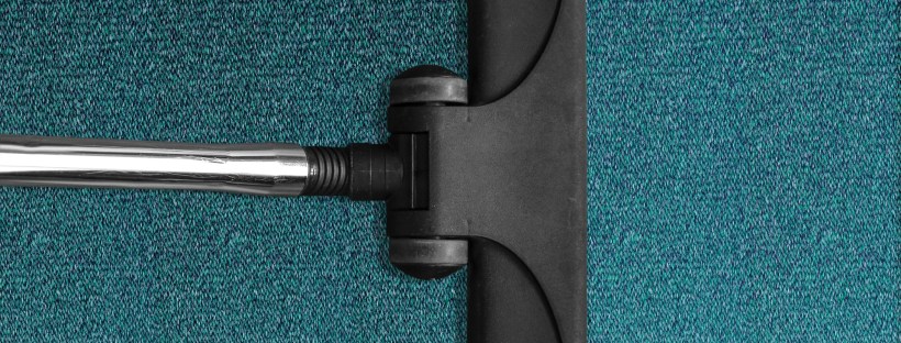 Image of a vacuum cleaner head cleaning a blue carpet